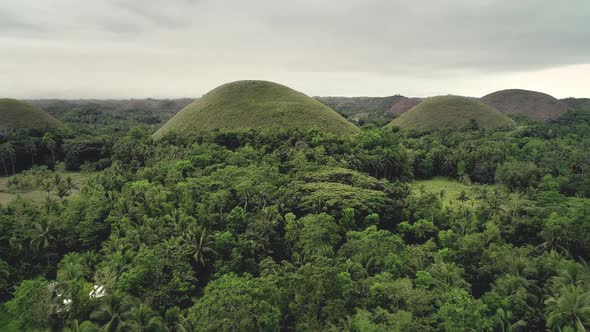 Philippines Chocolate Hills Hyperlapse Aerial Shot in Misty Cloudy Day. Amazing Natural Wonder alt