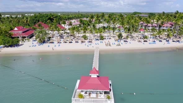 Drone pov flying over long pier and gazebo of Bahia Principe Hotel and Resort at La Romana, Dominica alt