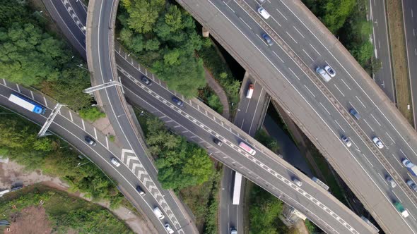 Vehicles Driving Through a Mixing Bowl Interchange Aerial View alt
