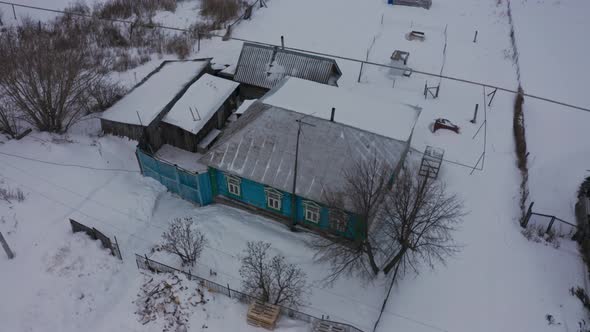 Old Wooden Houses in the Russian Village Covered with Snow