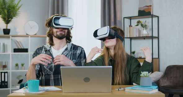 Couple Sitting at the Table at Home and Meditating Under Relaxed Peaceful Vision in VR alt