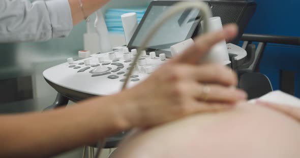 In the Hospital Closeup Shot of the Doctor Doing Ultrasound Sonogram Scan to a alt