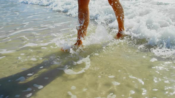 Low section of woman walking on the beach 4k alt