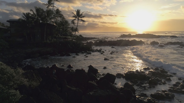 Drone Footage Of A Tropical Island Coast Silhouetted On A Golden Sunset alt