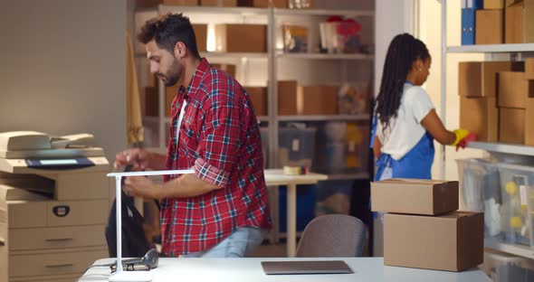 Small Warehouse Manager Leaving Workplace with Maid Cleaning Office alt