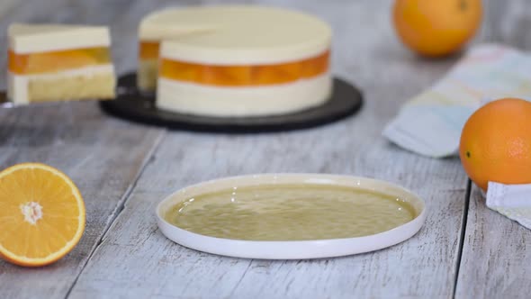 Piece of Orange Mousse Cake with Jelly and Orange Slices