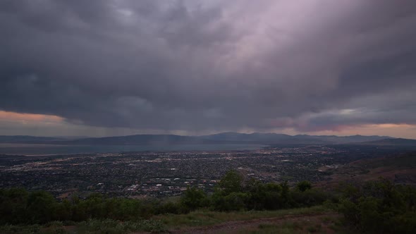 Time lapse at dawn from viewpoint over Utah Valley as the sun lights the clouds alt