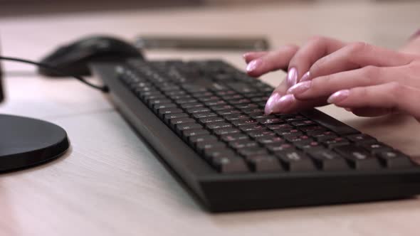 Female Fingers Work On The Keyboard