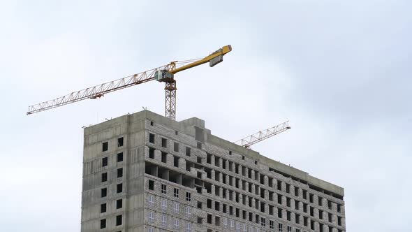 A Construction Crane Transports Cargo. Construction of a Multi-storey Building