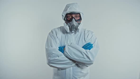 Portrait of a Confident Doctor in Protective Suit Folding His Hands on His Chest. alt