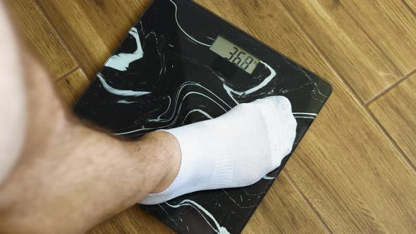 Human Weight Control, Male Legs In White Socks Stand On Floor Scales, 95.6 Kg Person