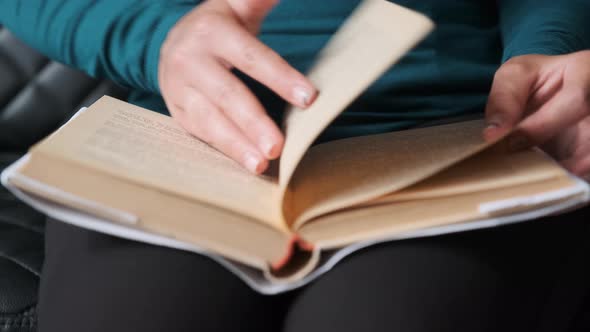 Young Woman Reading Book. Close-up Book Reading alt