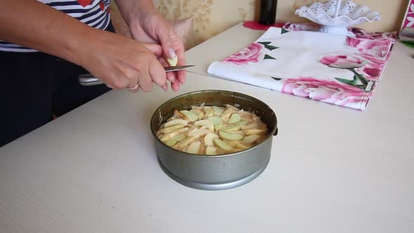 A Woman Makes An Apple Pie. Cooking Charlotte At Home. Shooting The Camera On The Slider.