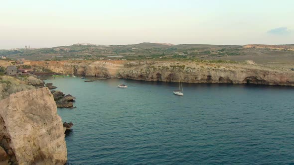 Majestic aerial view of the cliffs surrounding the lagoon with oldie set. Popeye village and anchor alt