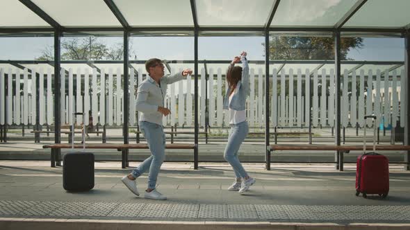 A Man and a Woman are Dancing Emotionally at a Bus Stop alt