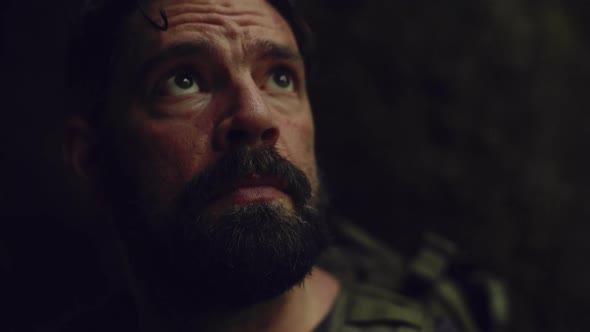 Detail of Male Hiker in Cave During Lightning Storm alt