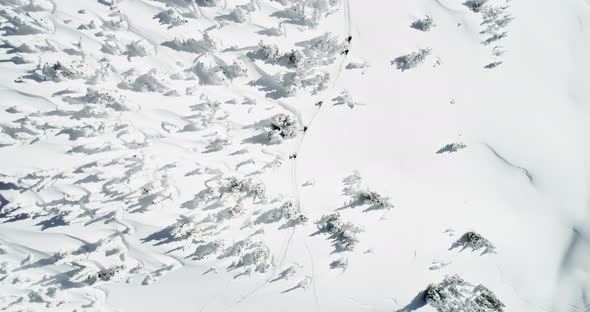 Skiers walking on a snow capped mountain 4k alt