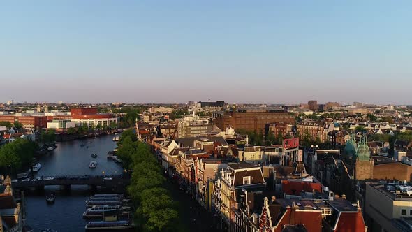 Aerial view of famous places, streets and canal in Amsterdam, Netherlands. Epic sunset colors
