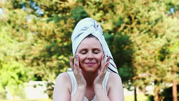Woman European Appearance Rubs White Moisturizer Open Air Her Dacha Garden with White Towel Her Head alt