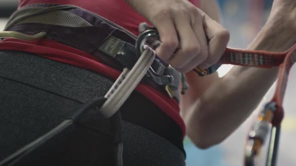 Sport Athletic Woman Secures the Safety Rope Carabiner Hook alt