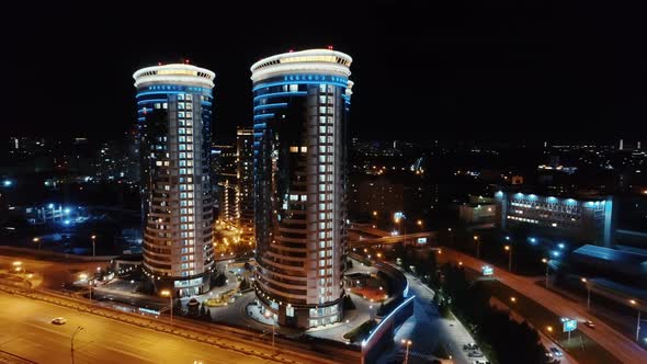 Modern Buildings with Illumination on the Background of a Big City alt
