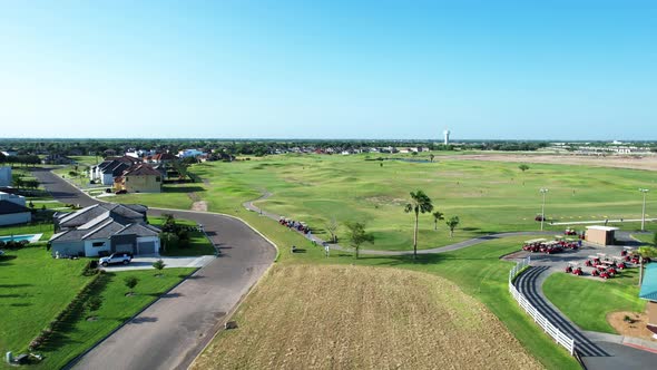 SUNNY DAY EDINBURG TX GOLF COURSE, PEOPLE PLAYING GOLF, RIO GRANDE VALLEY. GOLF CAR, DRONE FOOTAGE alt