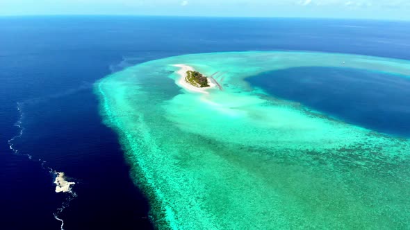Aerial: Flying over idyllic atoll, exotic travel destination in Wakatobi National Park, Indonesia alt