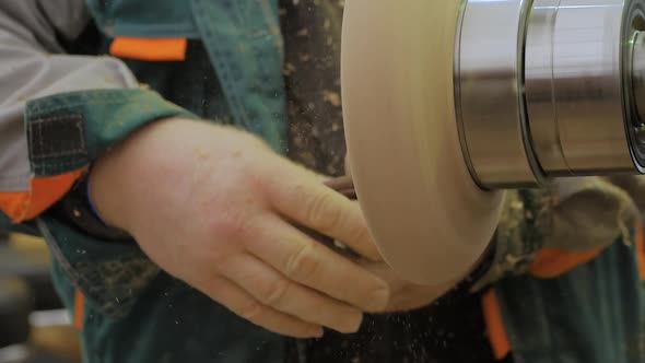 Slow Motion Man Using Sandpaper for Sanding Piece of Wood on Lathe  Close Up