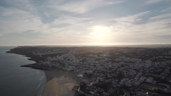 Scenic Fly-over Praia da Luz Townscape during cloudy evening, Algarve alt