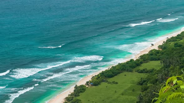 Tourists Arriving To Lonely Sandy Beach on Uluwatu Coastline, Bali, Indonesia alt