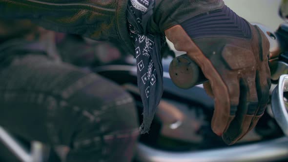 Hands of Motorcyclist on the Steering Wheel Closeup