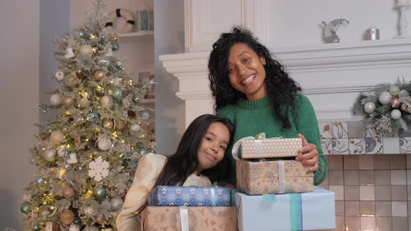Woman and Brunette Daughter Smile Holding Gift Boxes alt