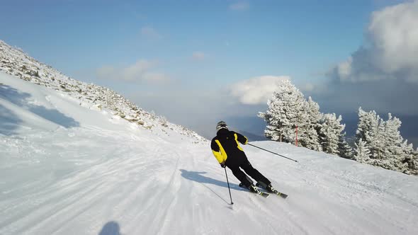Young adult recreational skier enjoys perfect weather in cold winter