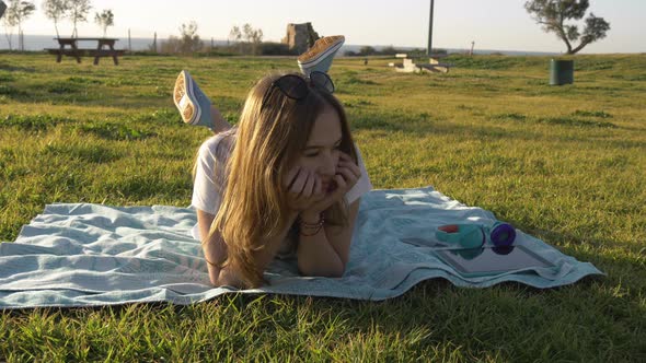 Young Female in Sunglasses Misses in the Green Park alt