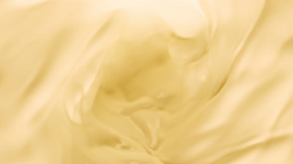 Super Slow Motion Shot of Swirling Yellow Milky Wortex at 1000Fps. alt