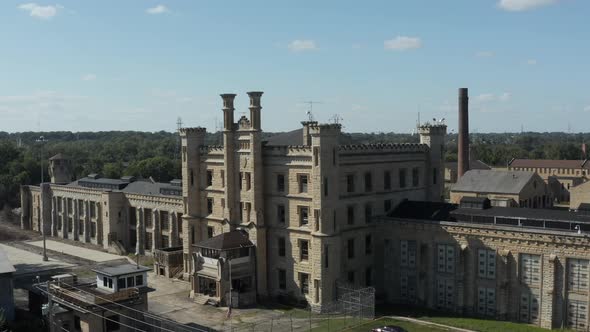Aerial view of the old and abandoned Joliet prison or jail, a historic site since 1880s. Drone rotat alt