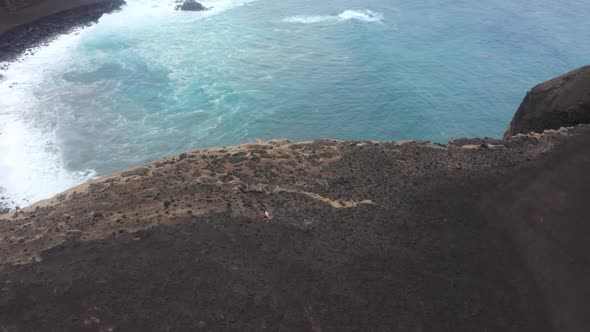Man Hiking at Capelinhos Volcano Crater Faial Island Azores Portuga Europe alt