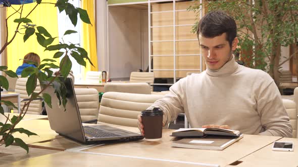 Man Reads the Book at the Working Hub alt