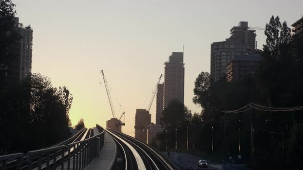 The Beautiful, Captivating Sunrise View Of Vancouver City Travelling From The Famous Millennium Line alt