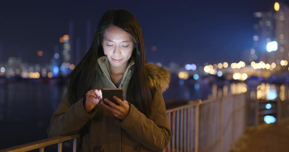 Young Woman Use of Smart Phone in City at Night alt