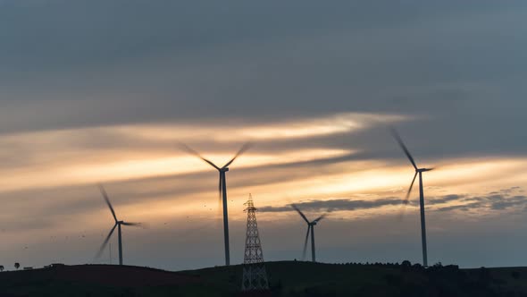 Footage B-roll timelapse power farm wind turbine while sunset time