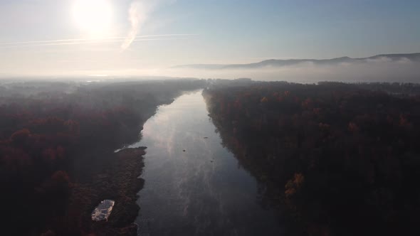 Aerial view of river channels with creeping morning fog.