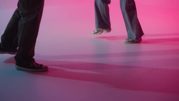 Professional Choreographers Legs Dancing Hip Hop on Color Changing Neon Background alt