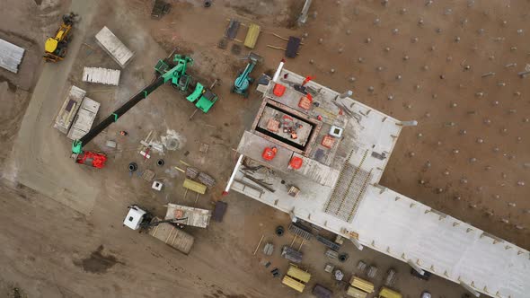 A construction crane is working at the construction site, lifting the working solution