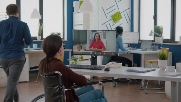 Handicapped Business Woman Talking About Sale Report in Video Conference alt