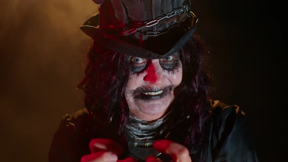 Sinister Elderly Woman with Horrible Scary Halloween Witch Vampire Makeup in Costume Trying to Scare alt