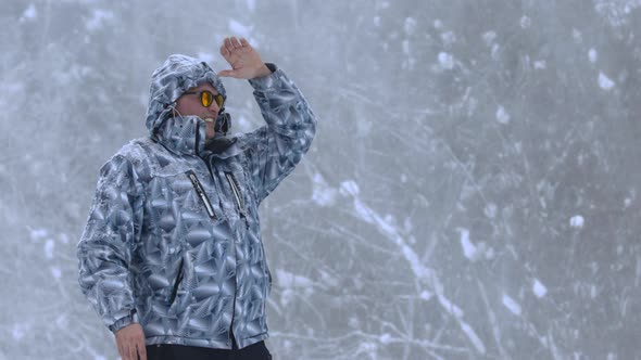 Man Stands Alone Against White Snowstorm and Snow Storm a Snowfall alt