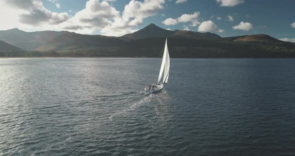 Slow Motion of Yacht Wind Blows to Sail at Ocean Aerial
