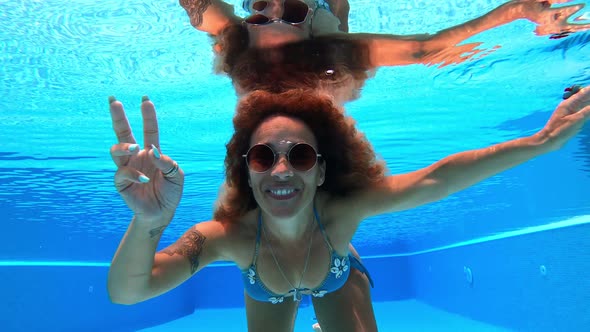 Young adult woman have fun and enjoy blue pool water in summer holiday vacation alt