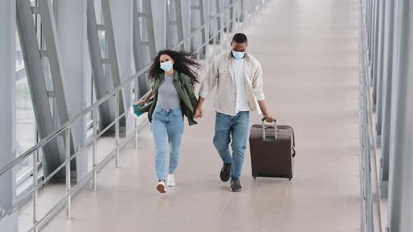 Happy Joyful Multiracial Couple African Man and Hispanic Woman Wearing Protective Medical Masks on alt
